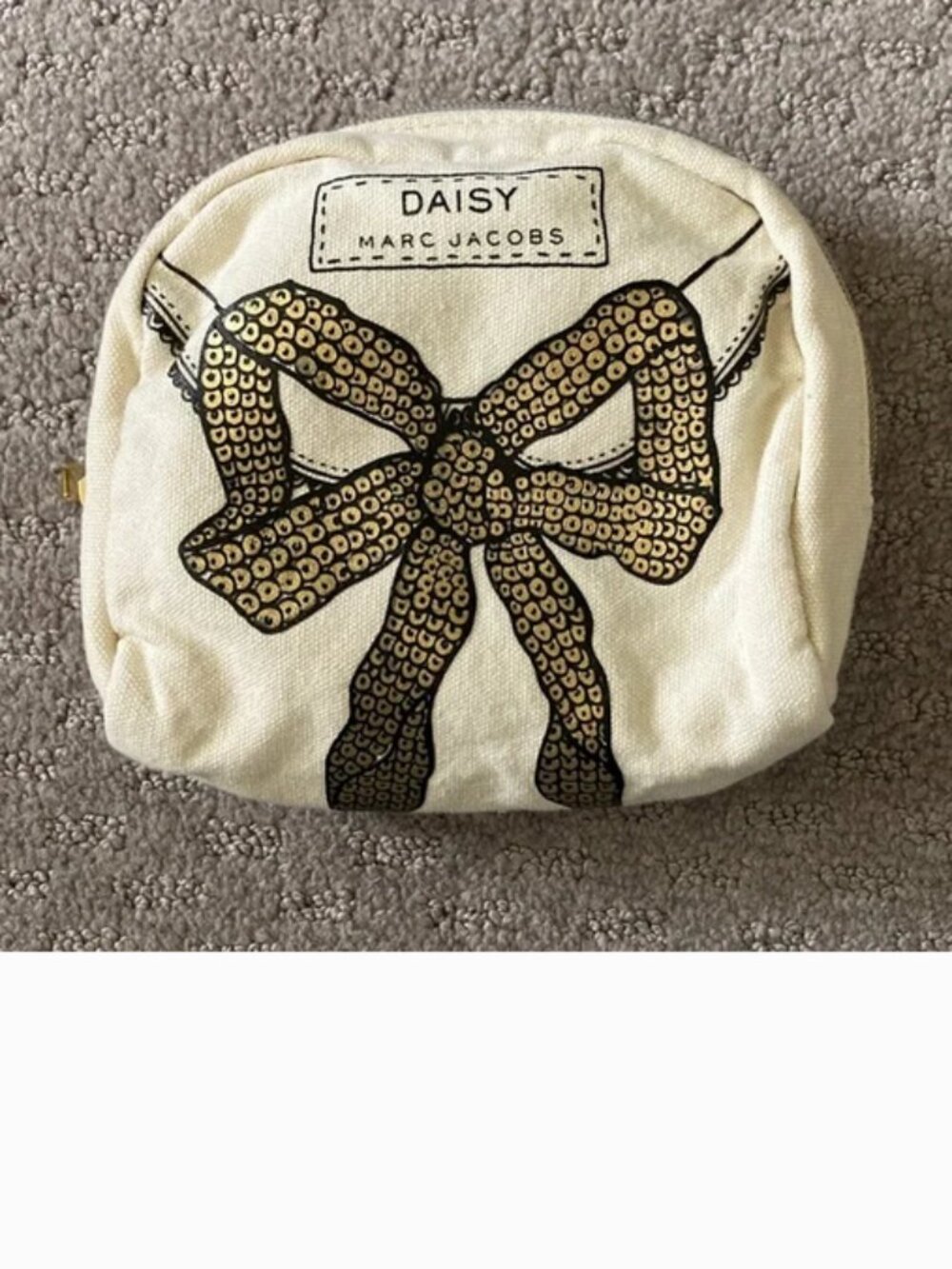 Daisy by Marc Jacobs gold bow cosmetic bag.